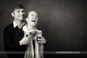 man and woman laughing together holding hands. Black and white photography. Relationship Couples portraits studio in Melbourne Beloved