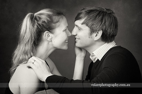 Couples Photography. man and woman looking lovingly at each other smiling. Black and white photography. Relationship portraits studio in Melbourne