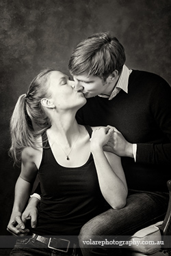 Couples Photography. man and woman holding hands and kissing gently. Black and white photography. Relationship portraits studio in Melbourne