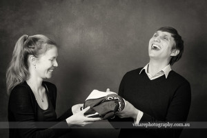 man and woman laughing together. Gifts. Black and white photography. Relationship Couples portraits studio in Melbourne Beloved