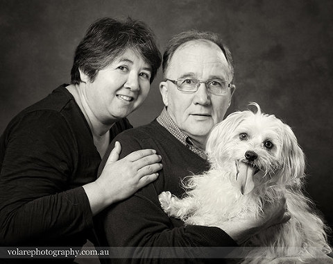 Family photograph of couple holding jack russell black and white portrait