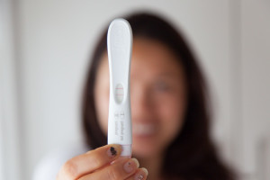 Happy woman with results of her pregnancy test