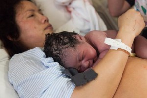 Child Birth Photography connecting with newborn