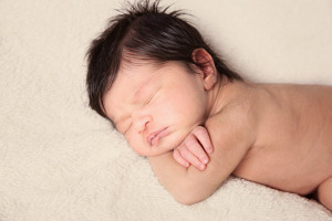 Natural newborn photographer overhead pose of baby boy