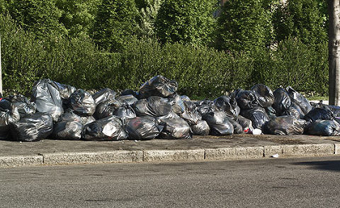 Garbage bags lined on street junk hoarders