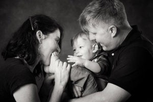 Black and white portrait mum and dad having fun with child melbourne