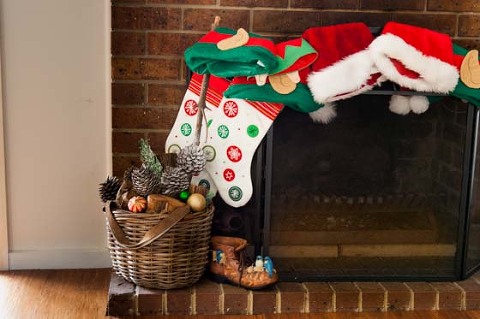 christmas stockings and fireplace with decorations