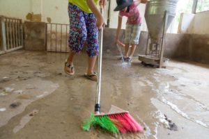 Cleaning duck droppings OGCDC Organic Farm for youths with disabilities