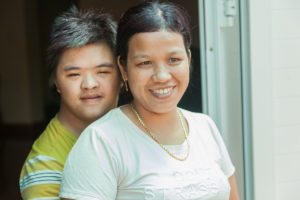 Posing for photos teacher and young man at The Organic Farm for Youngster with disabilities in Nam Dong OGCDC