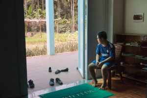 Young boy relaxing at The Organic Farm for Youngster with disabilities in Nam Dong OGCDC