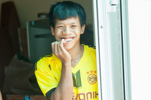 Young man at OGCDC Organic Farm for youths with disabilities Nam Dong Hue Vietnam