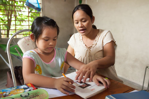 Mum helping young deaf girl with her speach therapy OGCDC Vietnam