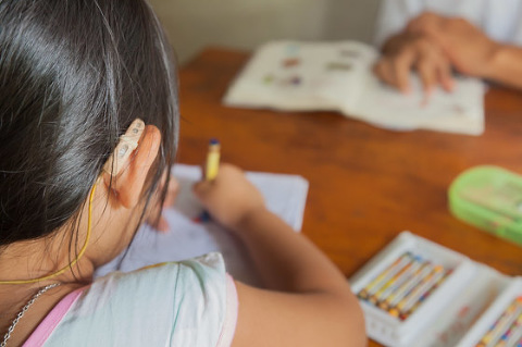 Young deaf girl with hearing aids Vietnam OGCDC