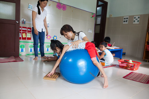Physical therapy for young girl with muscular and skeletal disability Early Intervention Centre Nam Dong