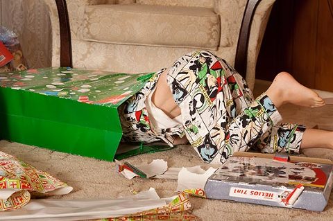 Little boy inside bag searching for christmas presents