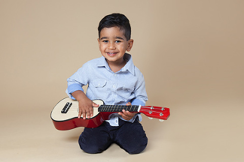 Young child playing guitar Melbourne kids studio photographer