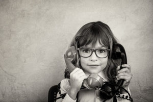 cute little girl holding two phones contact